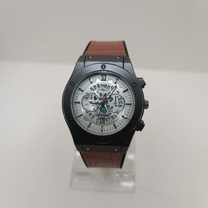 Hublot watch with brown leather strap on a white background