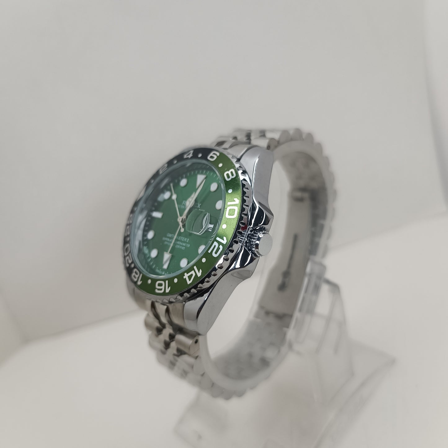 Stainless steel men’s GMT watch featuring green dial and rotating black bezel