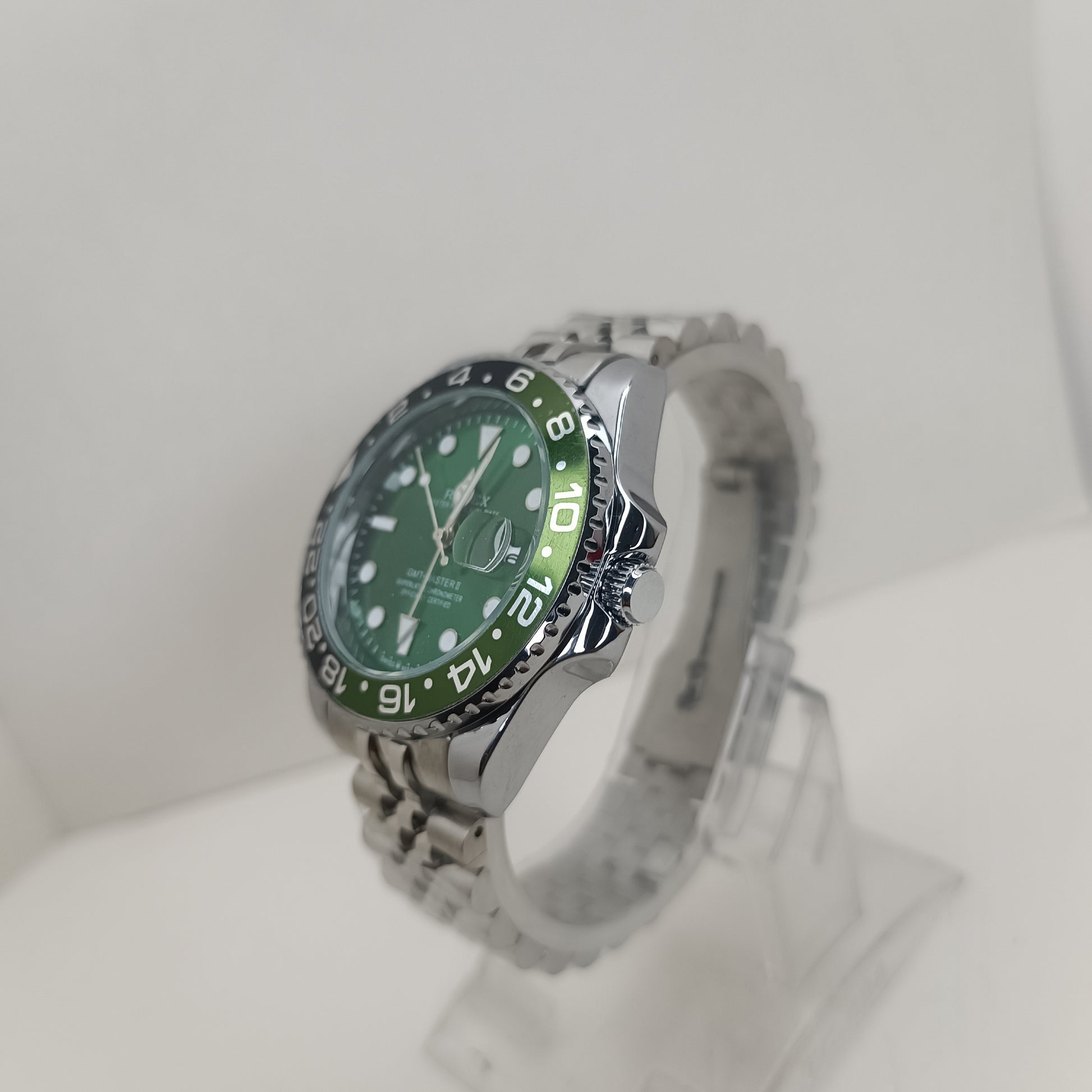 Stainless steel men’s GMT watch featuring green dial and rotating black bezel