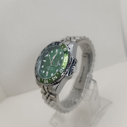 Stainless steel men’s GMT watch featuring green dial and rotating black bezel
